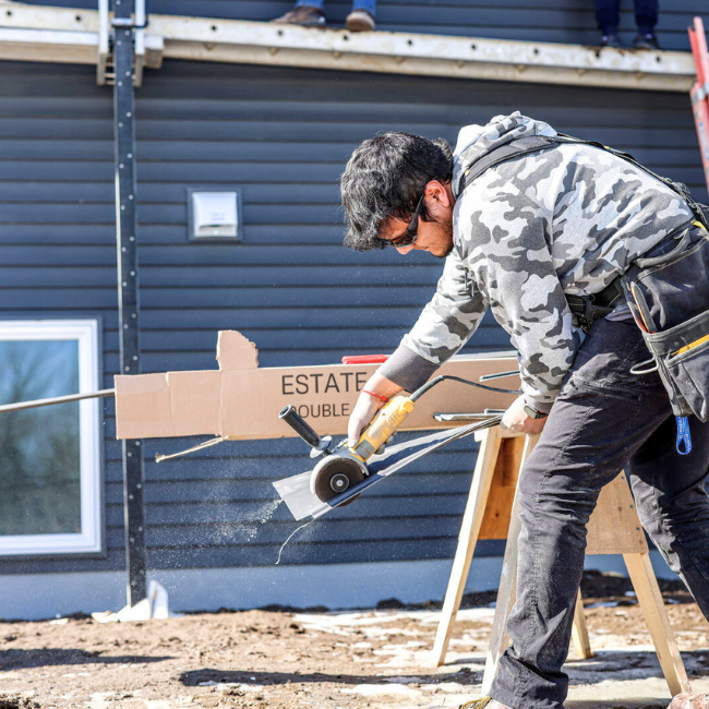 Student working in construction with a house.
