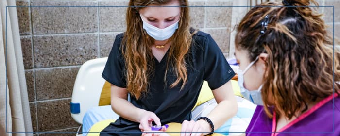 Nursing student practicing patient care in a clinical lab