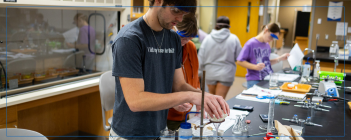 College students measuring liquids and performing a lab experiment