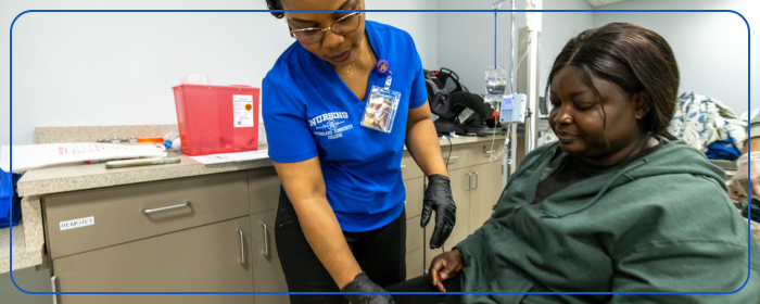 Nursing students help patient with IV