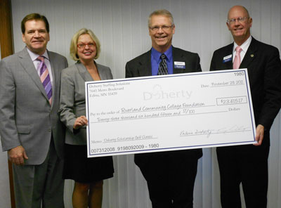Tim and Val Doherty, owners of Doherty Staffing Solutions, recently presented Riverland Community College Foundation a check for $23,615.17 to Steve Bowron, dean of institutional advancement and Dr. Terry Leas, college president. The money, raised at the Fifth Annual Doherty Scholarship Golf Classic held last June, provides scholarships to students attending Riverland.