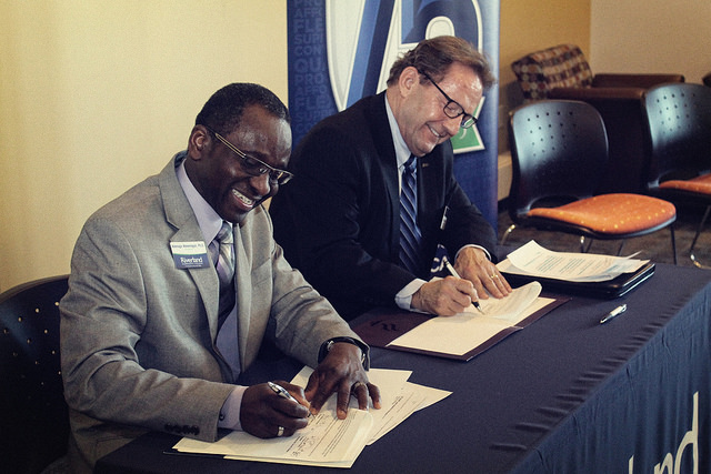 Riverland President Adenuga Atewologun and Minnesota State Mankato President Richard Davenport sign the International Student Pathway agreement.