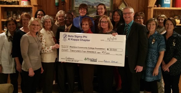 The Women of Beta Sigma Phi- Xi Kappa Chapter in Austin presents a check for $8,500 to Dr. Adenuga Atewologun, president of Riverland Community College and Steve Bowron, Riverland dean for institutional advancement, to begin their endowed scholarship to support Riverland non-traditional female students from Mower County.